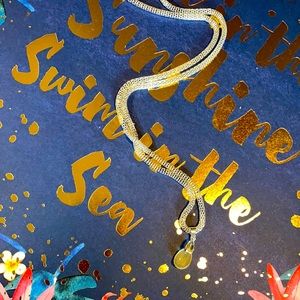 21” handmade silvertone necklace with yellow sparkle resin teardrop pendant.